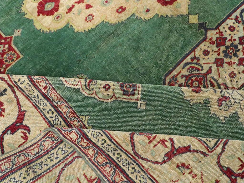 Early 20th Century Green, Red, and Beige Distressed Rug For Sale 1