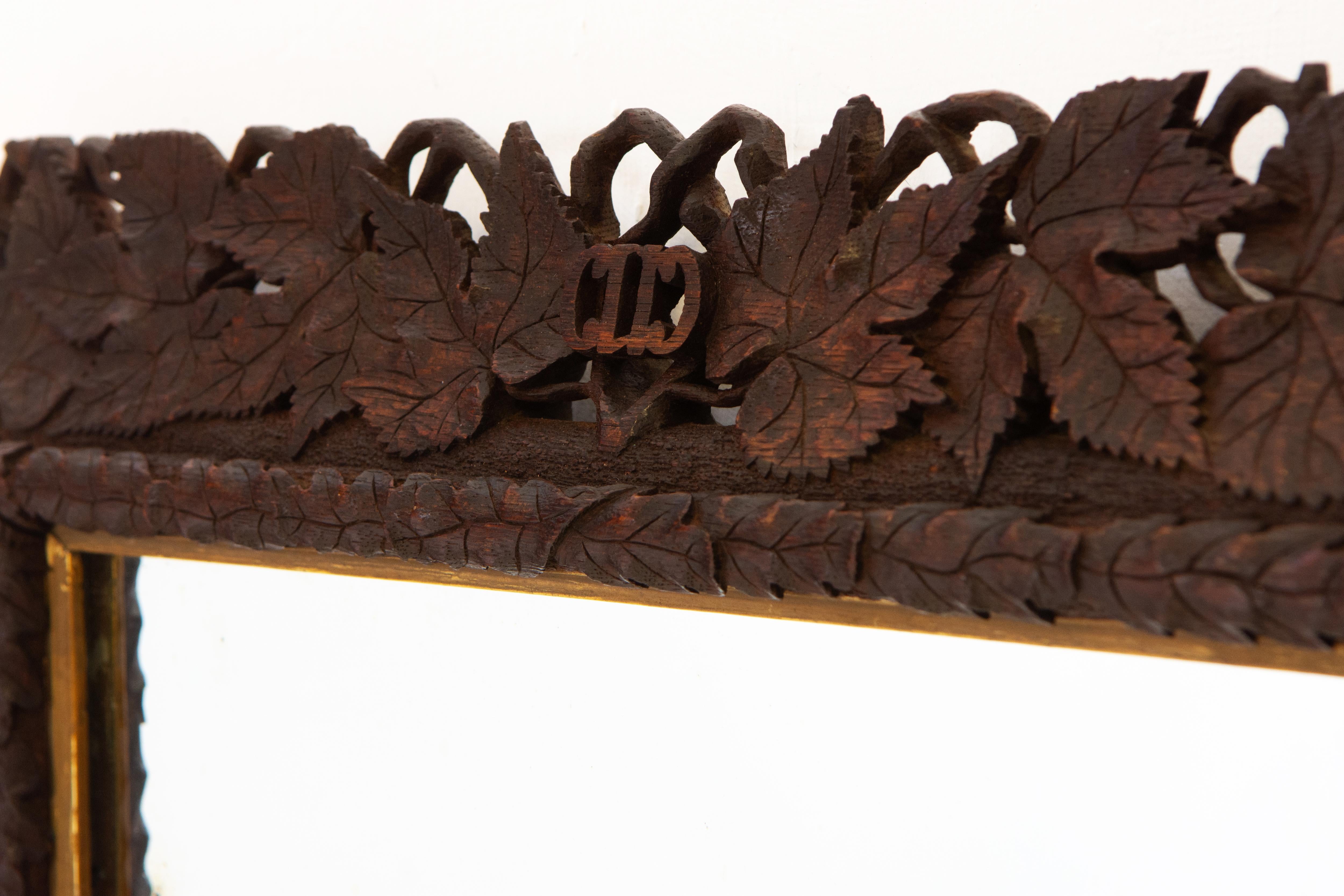 German Early 20th Century Hand Carved And Giltwood Black Forest Oak Wall Mirror  For Sale