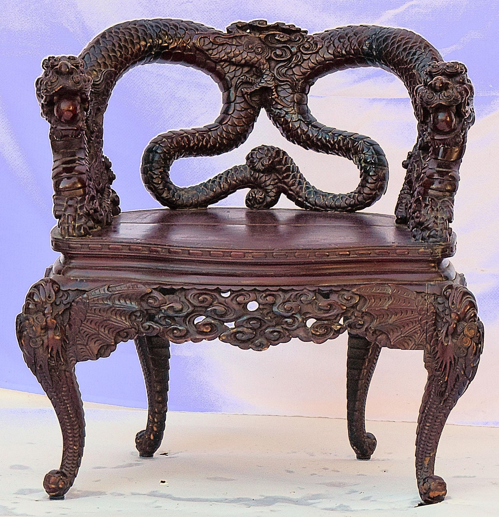 Dark stained elm hardwood open armchair, the back carved with twin entwined dragons bodies with dragon's head arm terminals and a wood seat on cabriole legs,

circa 1900.

bkx1