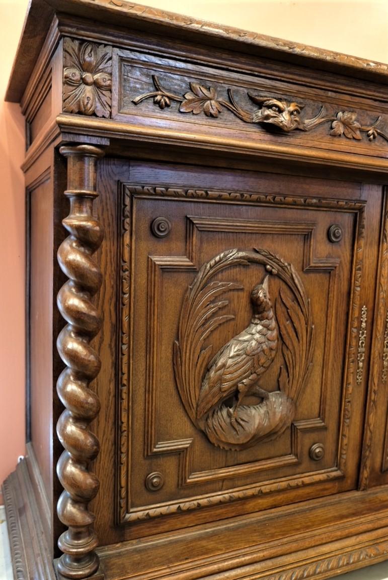Beautiful hand carvings enhance this early 20th century serving cabinet. Cabinets and drawer locks in working condition.