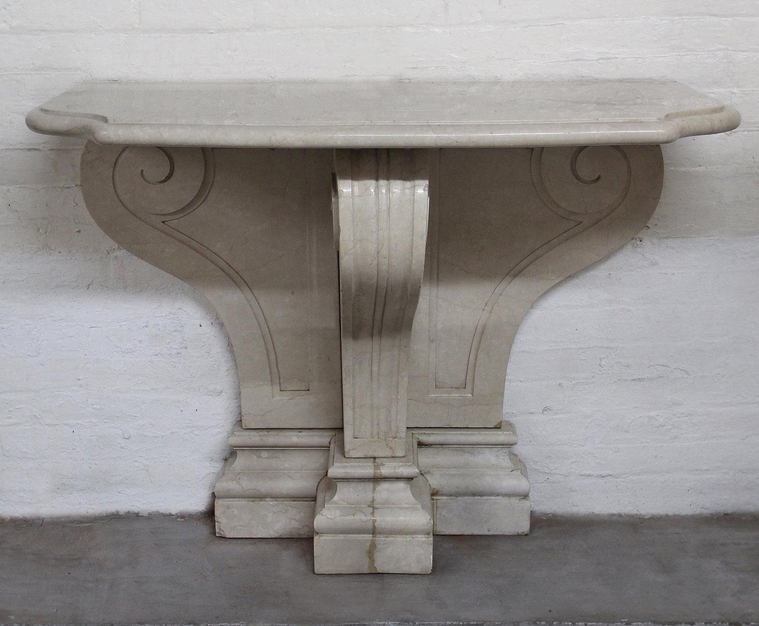 Early 20th Century Hand Carved White Marble Console

The shaped marble top above the scrolling backsplash with a single central leg.

