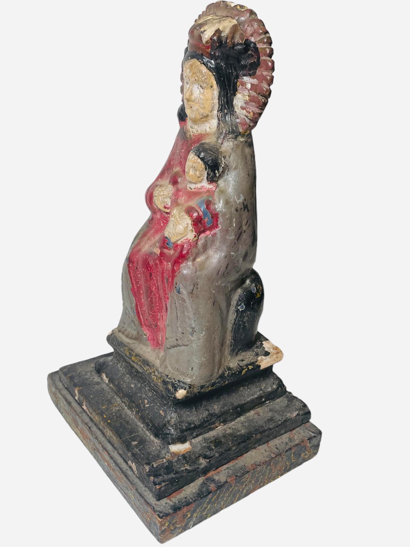 A renowned tradition in Latin America and Puerto Rico is the making of Santos de Palos by master carvers since the 19th century. This is an early 20th century wood plaster carving sculpture of Our Lady of Monserrat and baby Jesus. It was hand carved