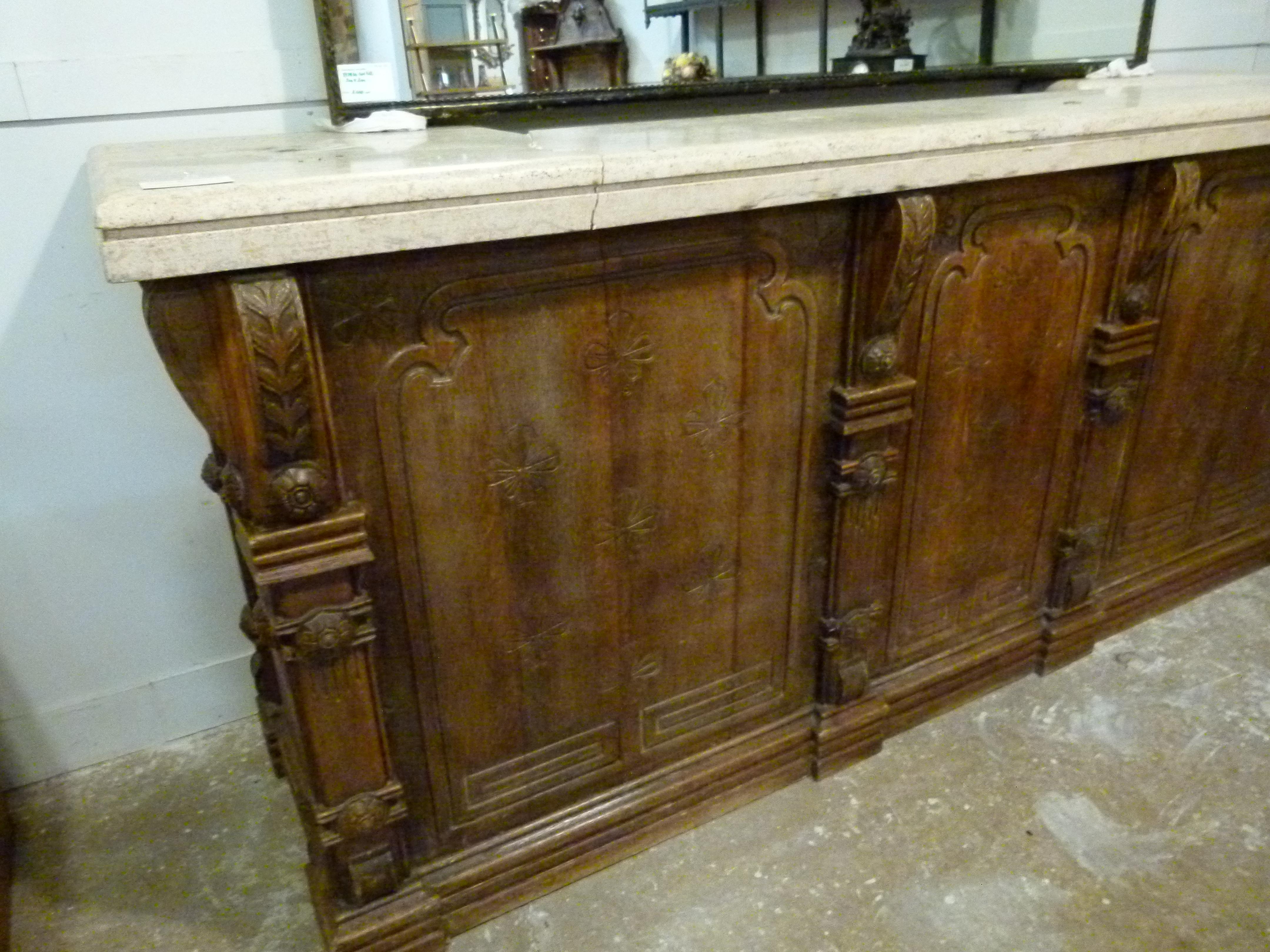 Early 20th century dry bar with a thick marble top and wooden hand carved base.
No drawers or shelves at the interior side.
he bar belonged to a hotel in Barcelona


            