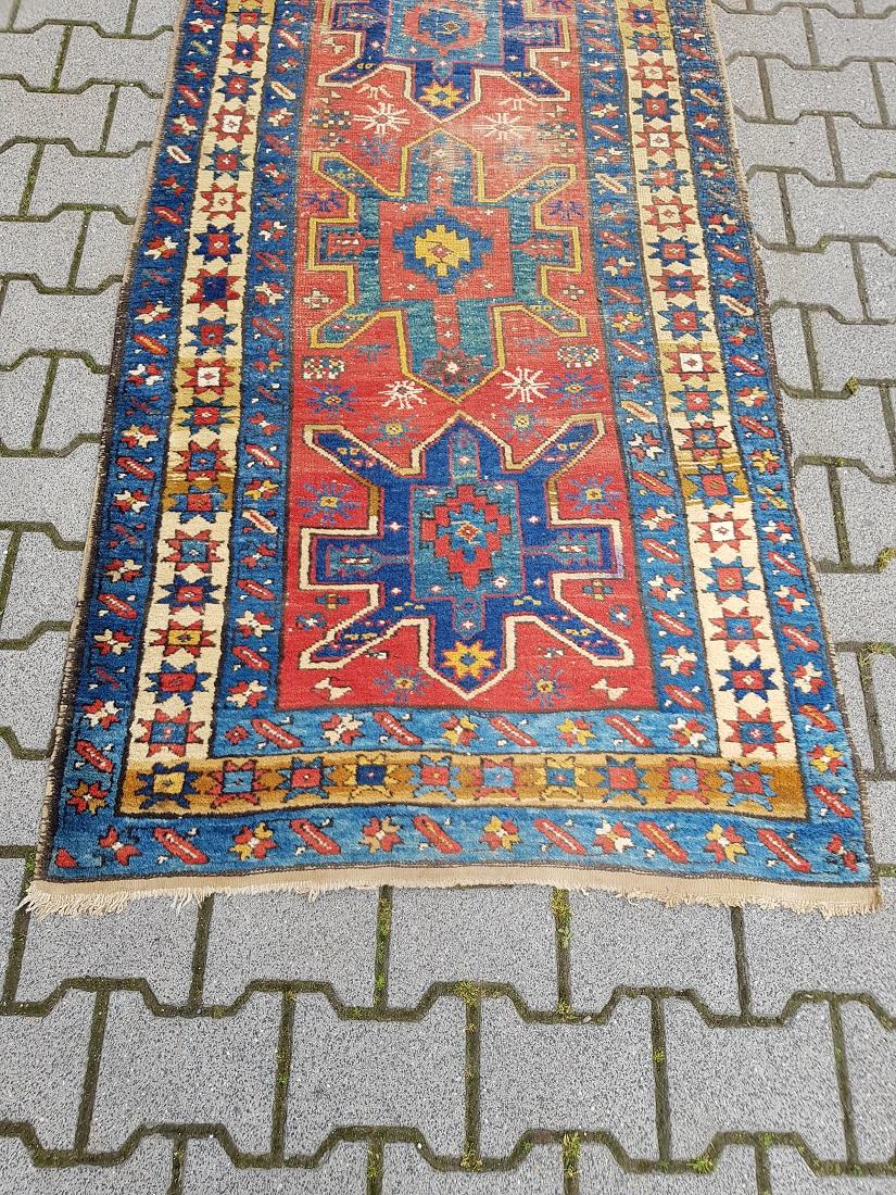 Antique hand knotted Caucasian runner made of wool on cotton warp and is nicely worn around the years and it has some old moth wear but still very colorful, early 20th century. 

The measurements are,
Width 97 cm/ 38.1 inch.
Long 310 cm/ 122
