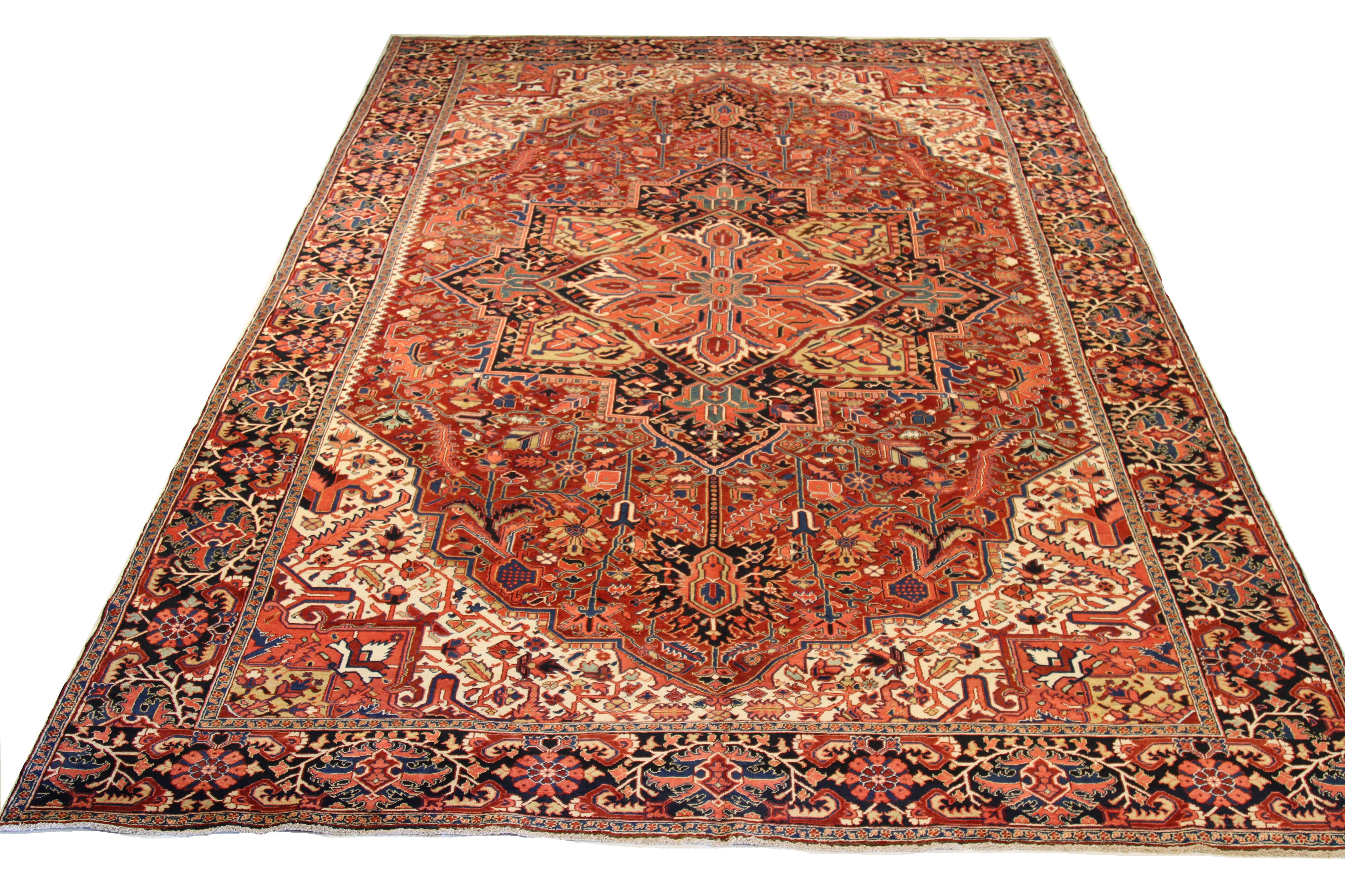 Large early 20th-century hand knotted Persian area rug made from fine wool and all-natural vegetable dyes that are safe for people and pets. This beautiful piece features ornate floral patterns in various colors which Heriz rugs are known for.