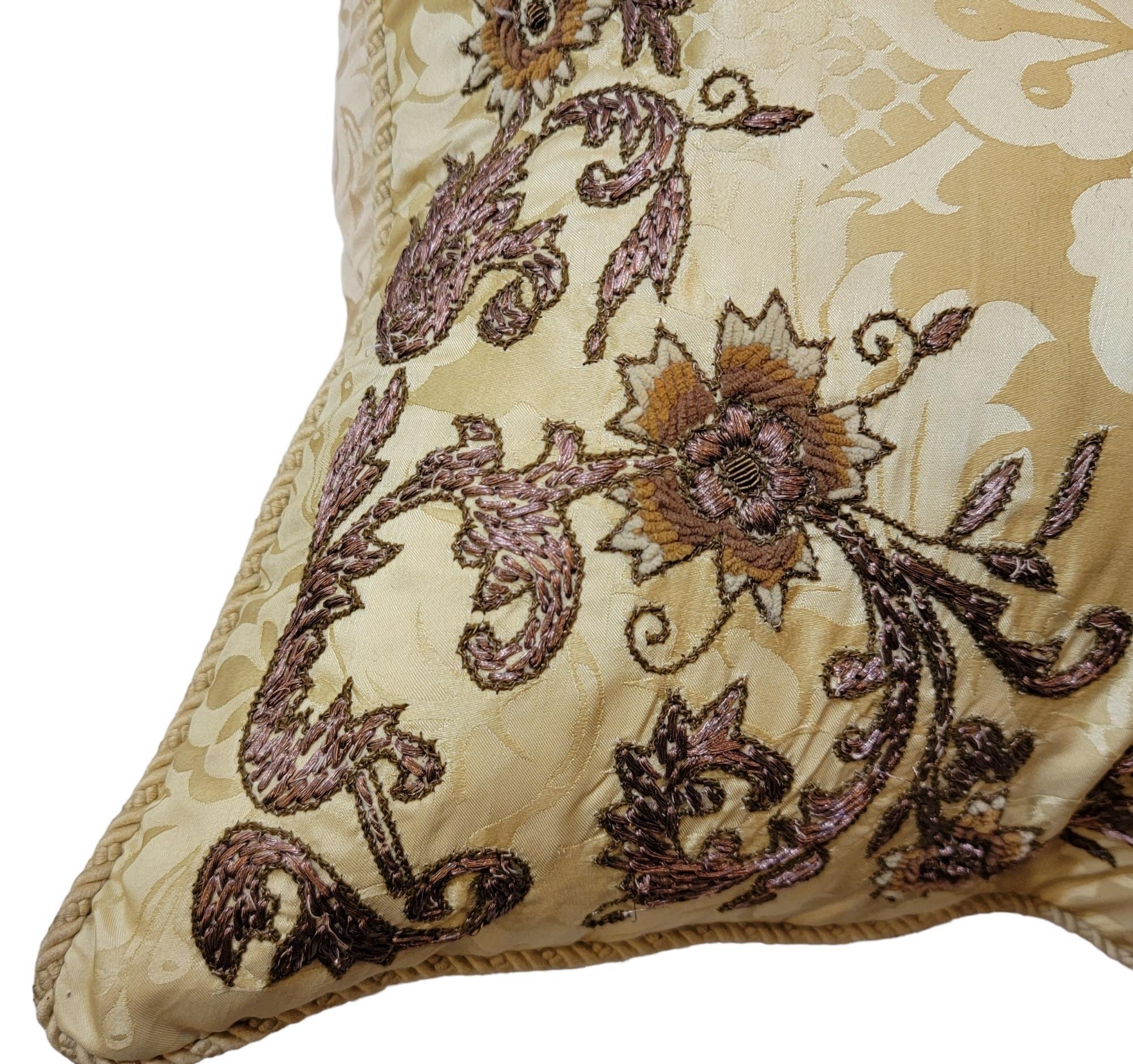 Hand Sewn Floral pillow with copper wire sewn throughout the pillow. The pillow has spots of cotton that outline the floral pattern and the maker has sewn copper wire into the decoration. The copper is limited to the interior of the outline. The