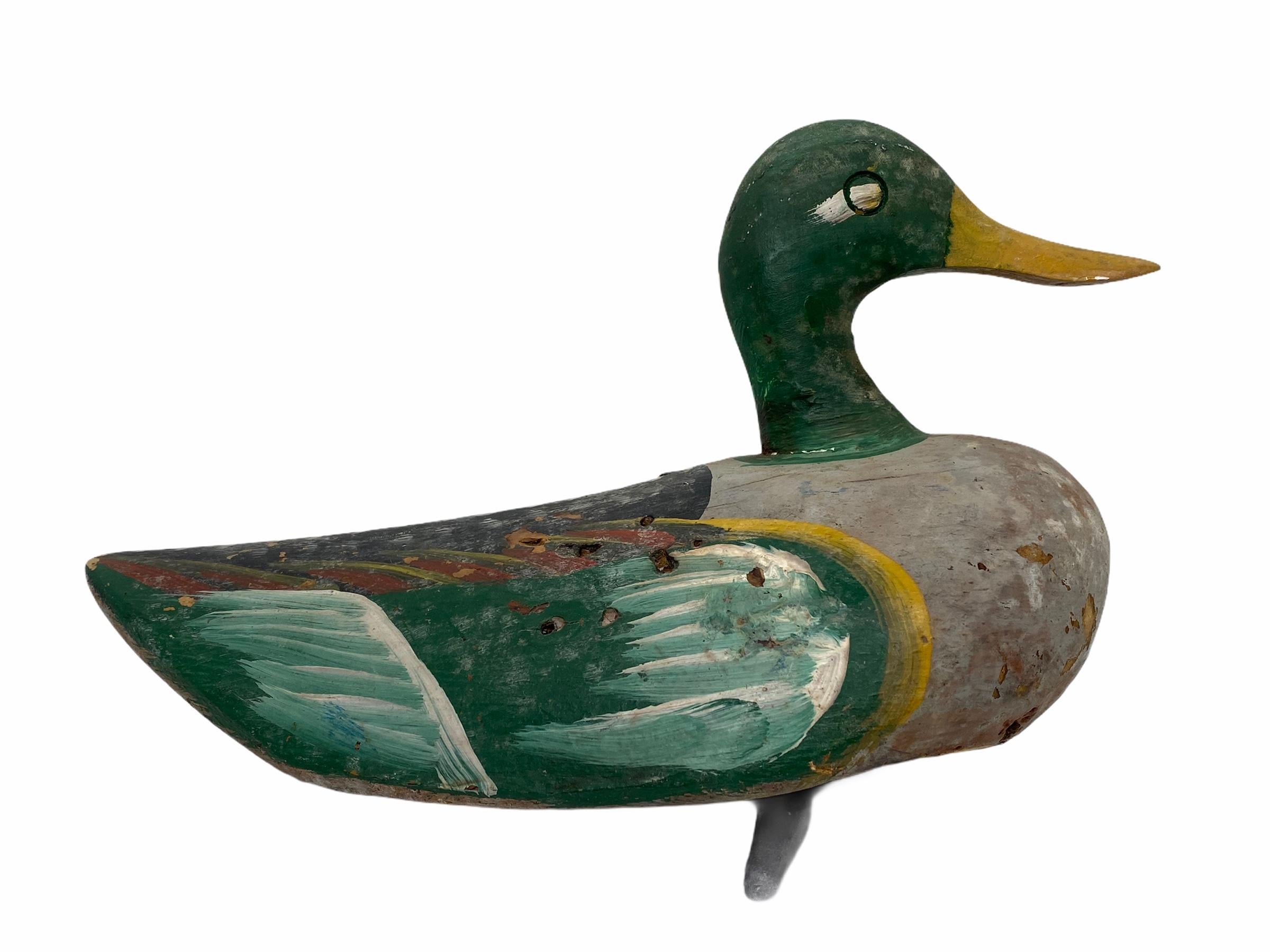Found in Germany at an estate sale, this hand carved and hand painted duck decoy is perfect for the collector. Well used by a previous hunter the paint has faded through time although the original detail can be seen and admired. Nice folk art