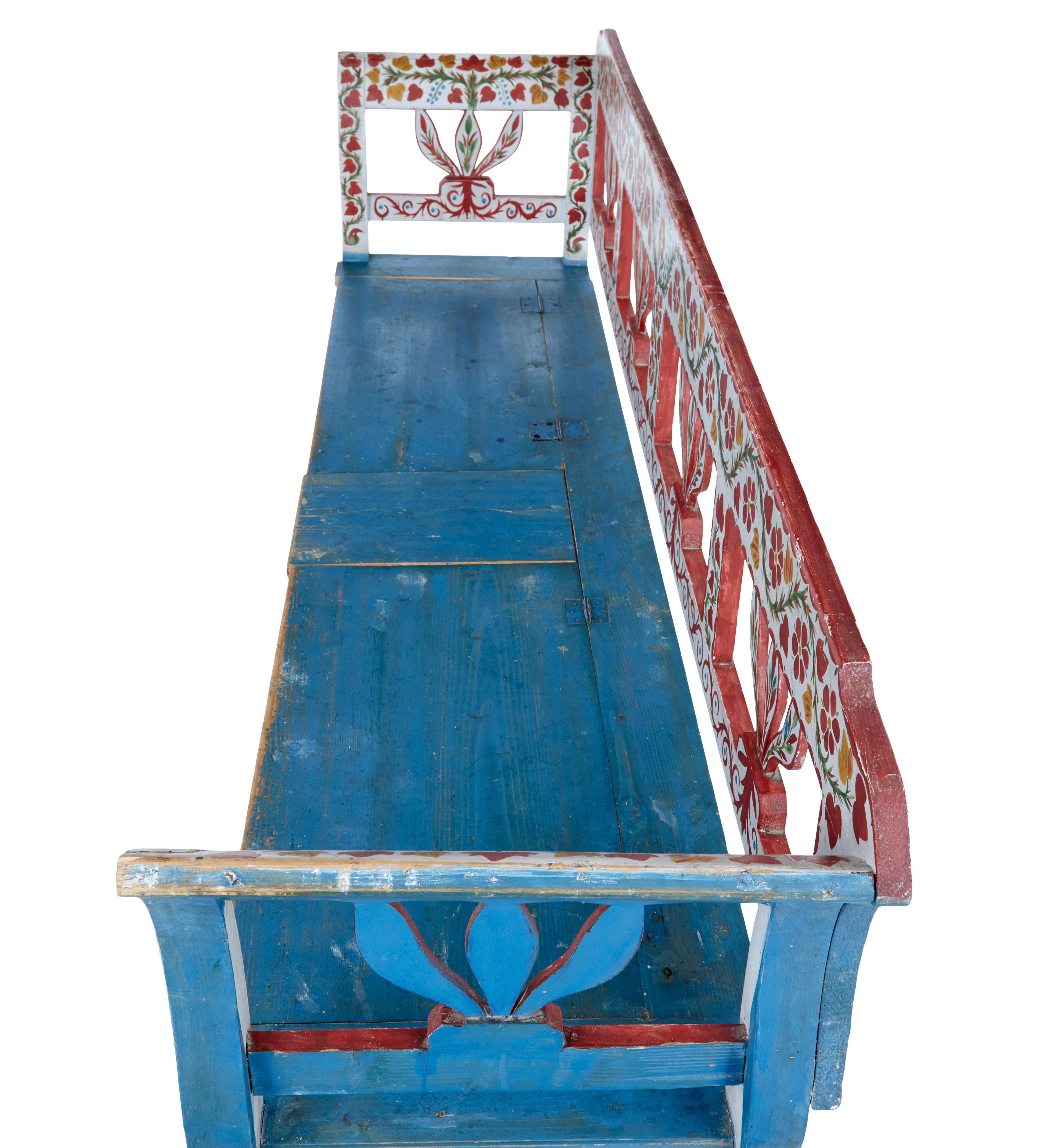 Early 20th century hand painted folk art pine bench circa 1900.

Fine quality Hungarian traditional hand painted bench.  White,red and green floral design to the front and back rest, completed with a contrasting blue to the sides and