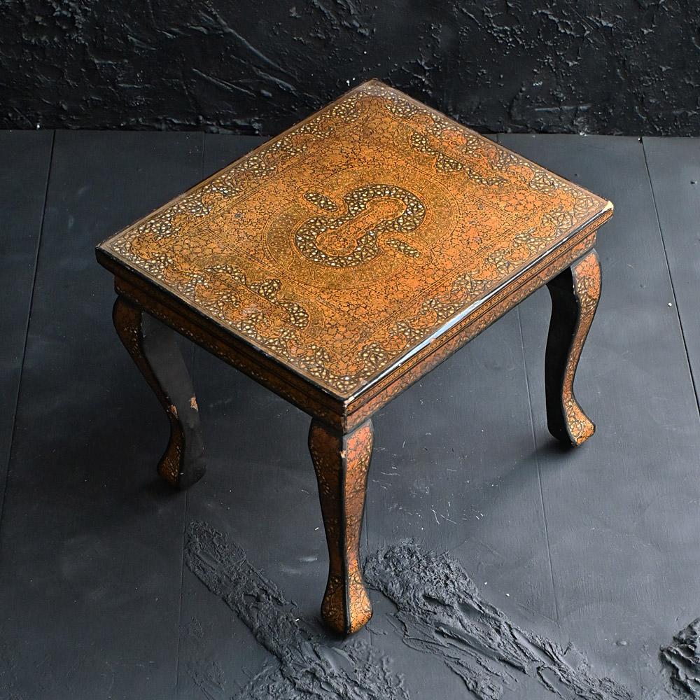 Early 20th Century Hand Painted Kashmiri Side Table 

A highly decorative example of an early 20th Century Kashmiri side table in gold and black. An intricate geometric hand painted gold and black example. 

Dimensions in inches: H 13” x W 16” x D