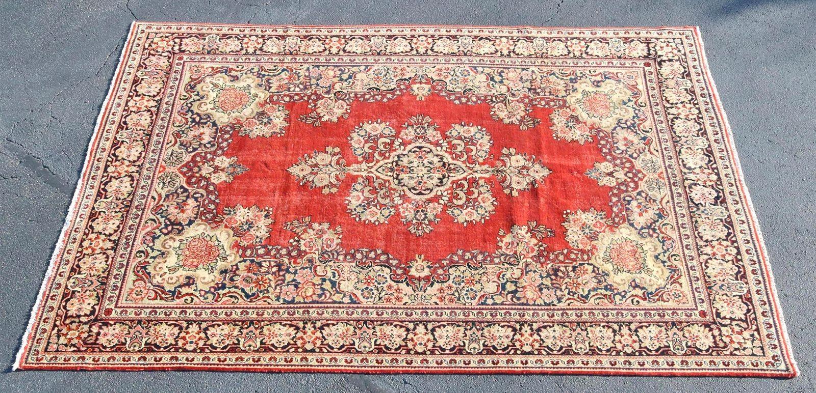 Magnificent hand-tied Persian Mahal rug made in the early 20th Century, adorned with a myriad of symbolic ancient motifs. Predominantly in red tones, with deep blue details, it seamlessly weaves together intricate botanical elements through its