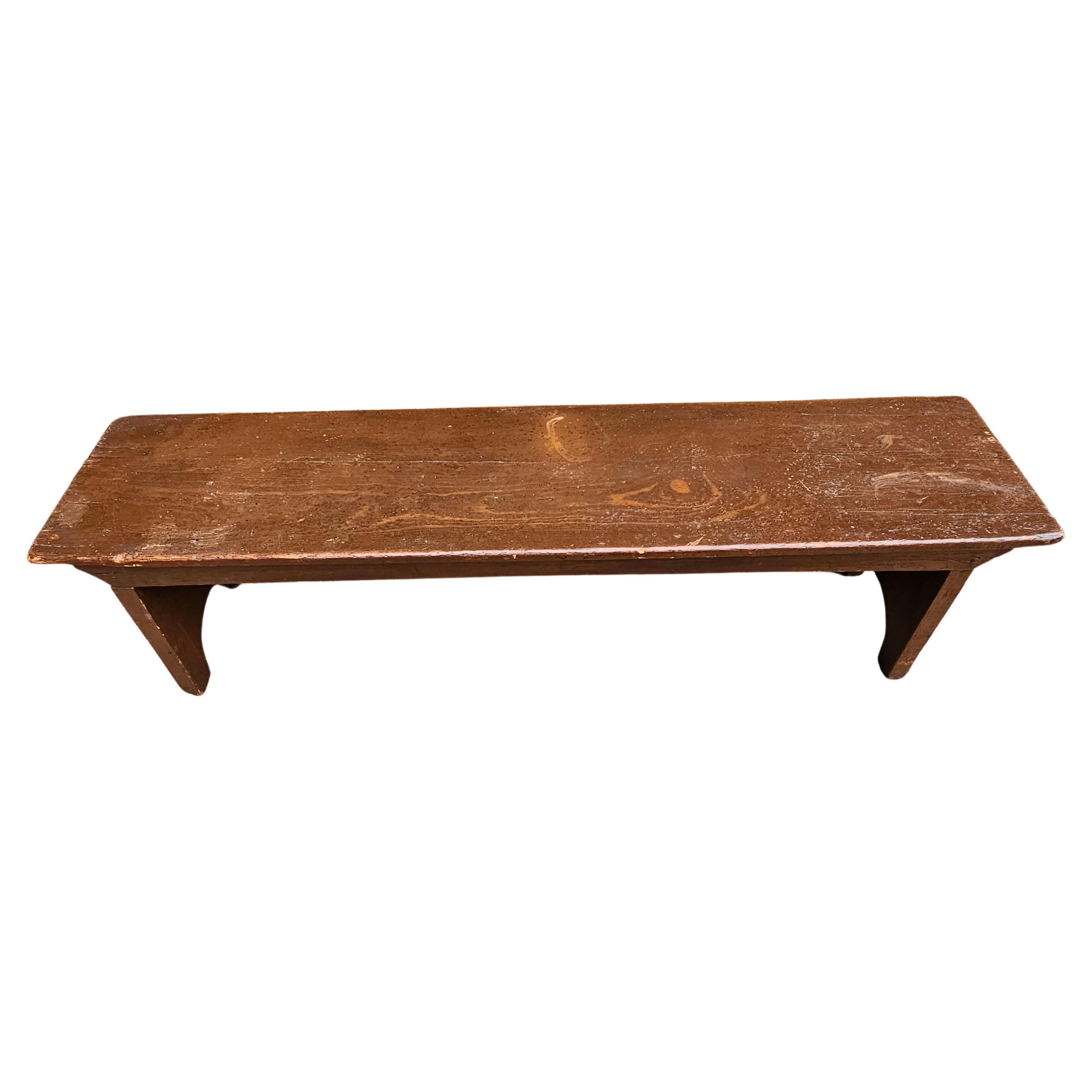 An Early 20th Century Handcrafted American Colonial Elm Low Bench. Measures 41.5