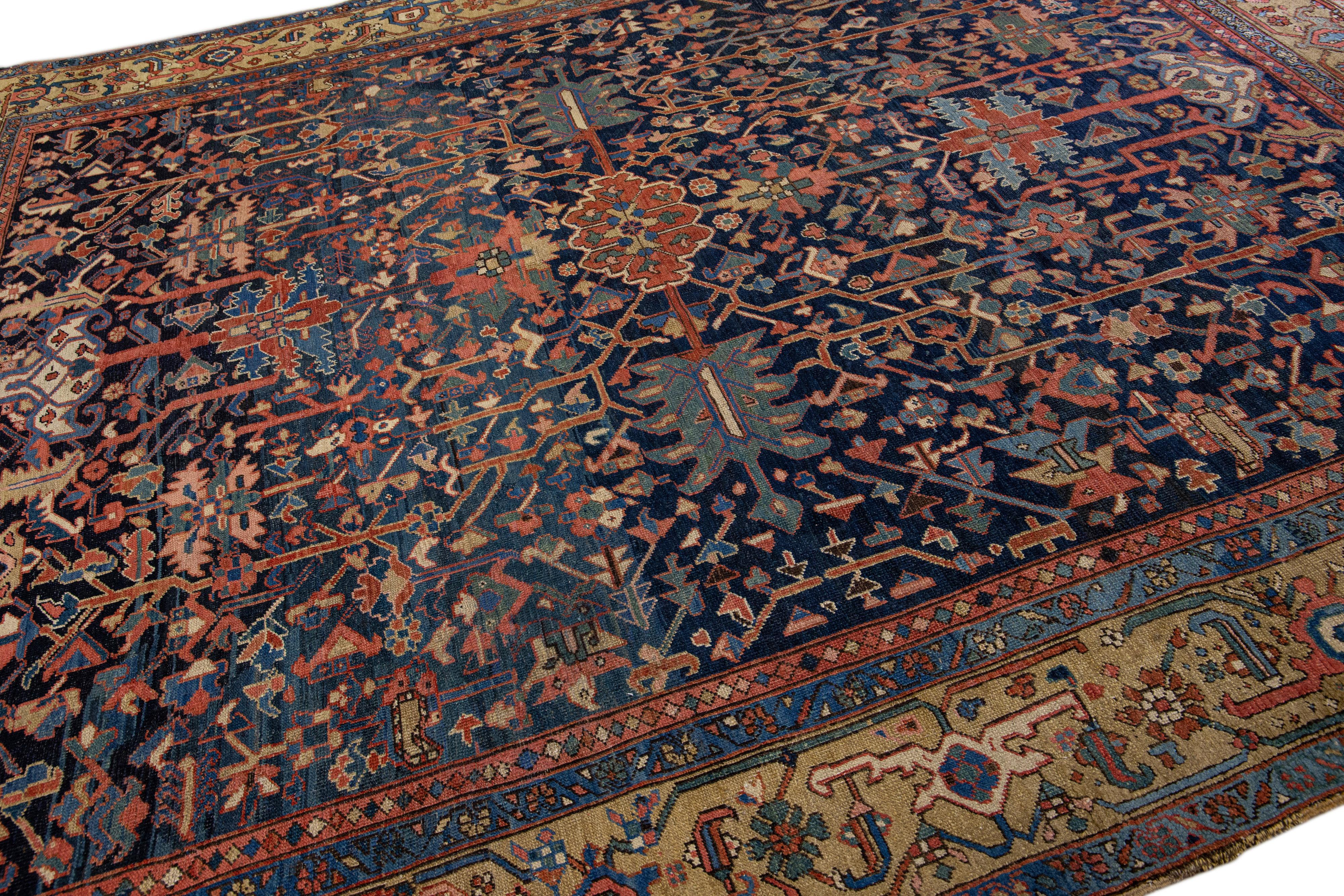 Beautiful antique Heriz hand-knotted wool rug with a blue field. This Persian rug has brown accents in a gorgeous all-over geometric floral design.

This rug measures: 9'8