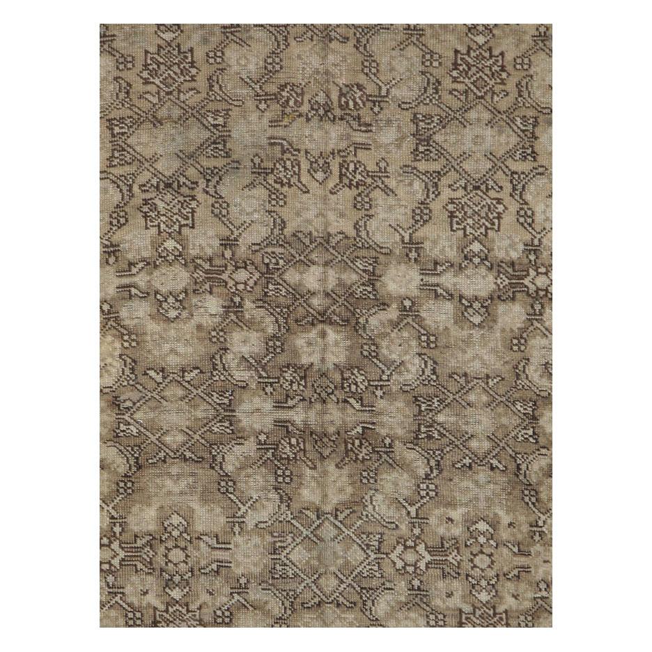 An antique Caucasian Karabagh accent rug in gallery format handmade during the early 20th century with a predominantly neutral palette in browns.

Measures: 5' 0