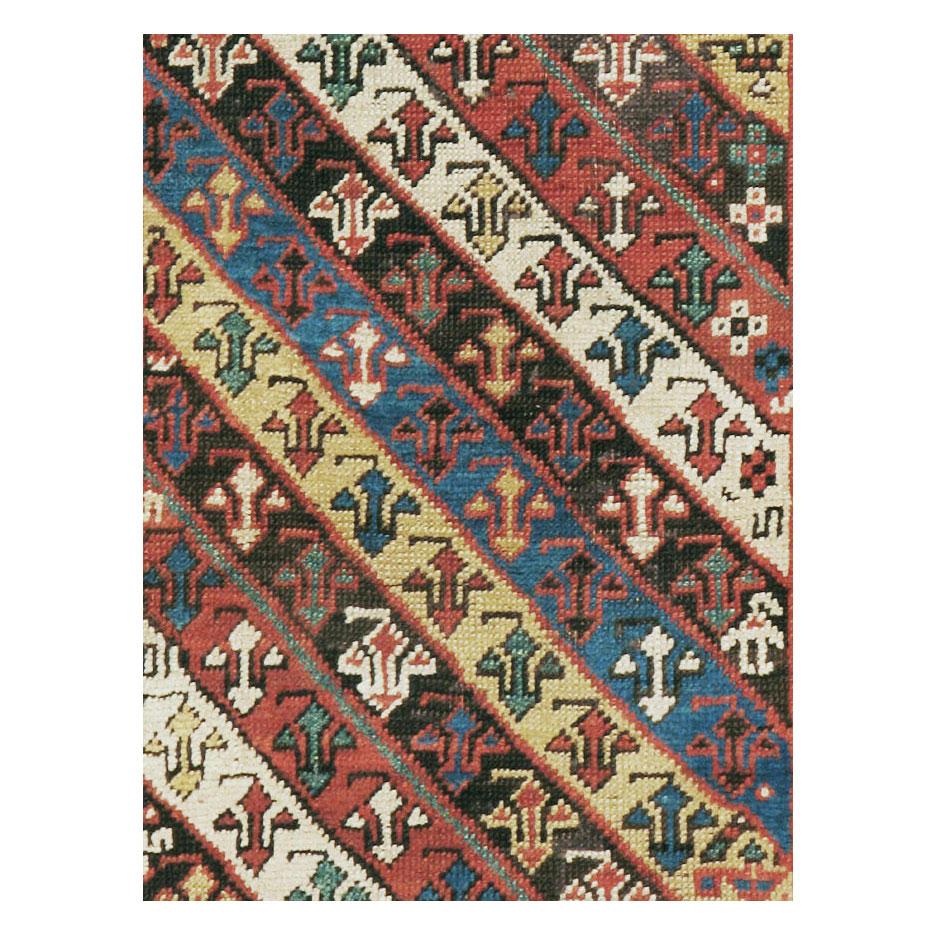 An antique Caucasian Kazak rug in runner format handmade during the early 20th century with a geometric tribal design.

Measures: 3' 1