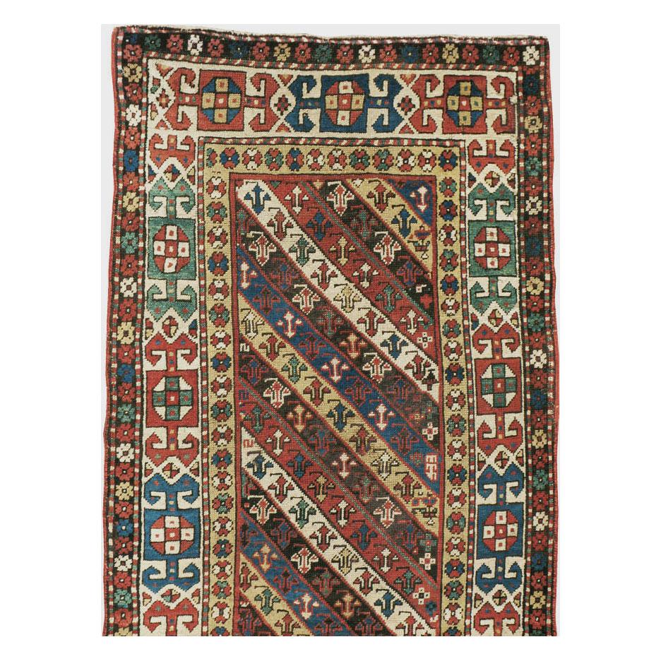 Hand-Knotted Early 20th Century Handmade Caucasian Kazak Runner with a Tribal Design For Sale