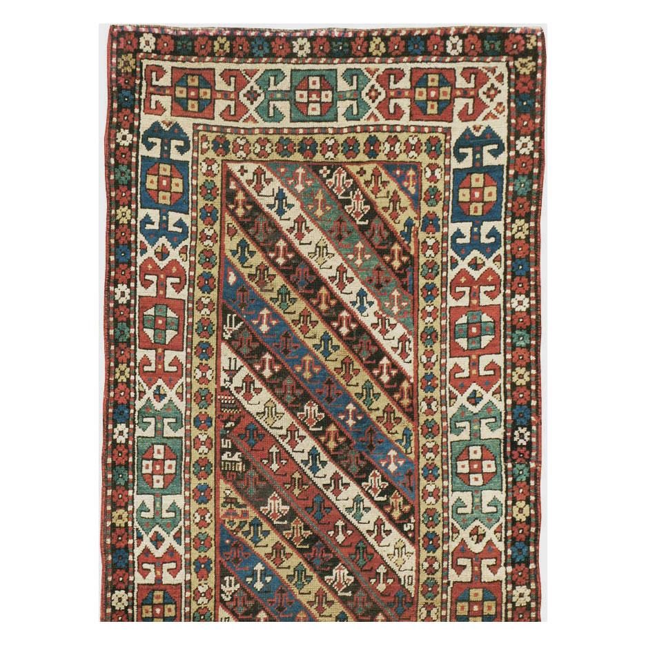 Early 20th Century Handmade Caucasian Kazak Runner with a Tribal Design In Excellent Condition For Sale In New York, NY