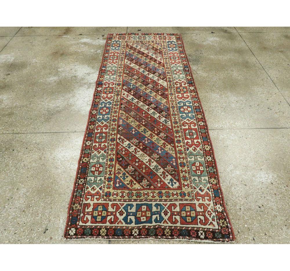 Wool Early 20th Century Handmade Caucasian Kazak Runner with a Tribal Design For Sale