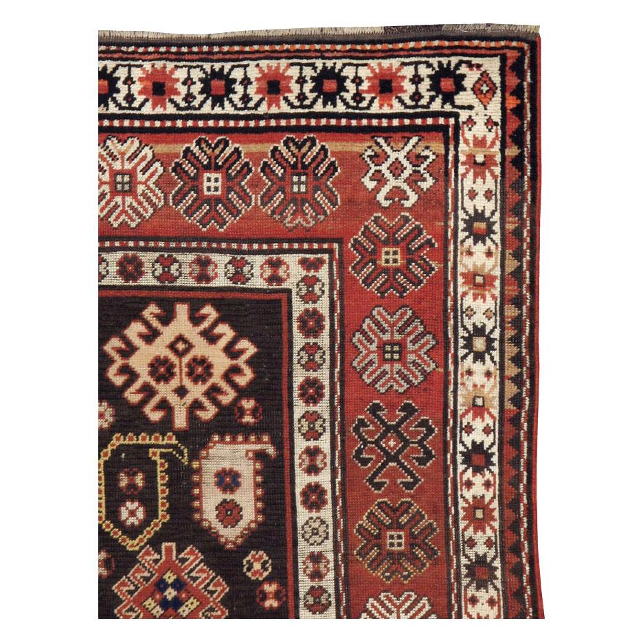 An antique Caucasian Kazak throw rug handmade during the early 20th century.

Measures: 3' 6