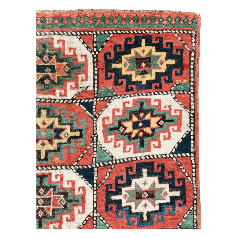 An antique Caucasian Kazak throw rug handmade during the early 20th century.

Measures: 2' 7