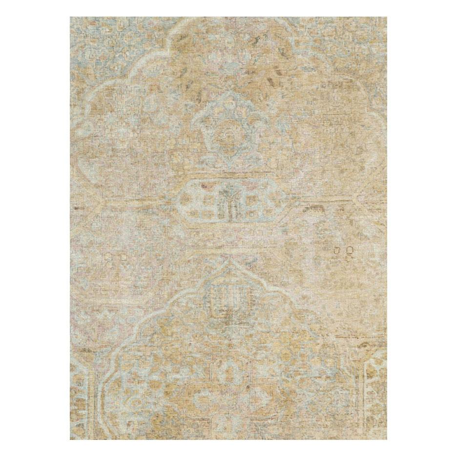 An antique Persian Tabriz accent rug handmade during the early 20th century with a distressed appeal, but otherwise in very strong and durable condition.

Measures: 6'10