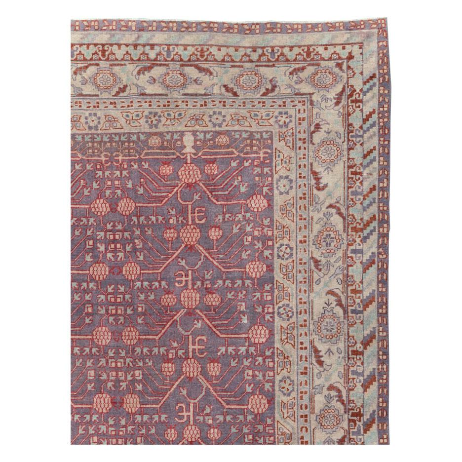 An antique East Turkestan Khotan room size carpet handmade during the early 20th century.

Measures: 9' 6