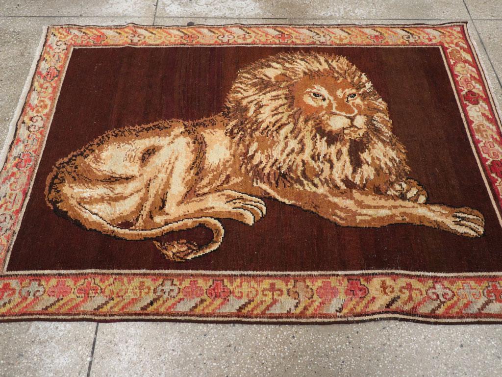 An antique East Turkestan pictorial lion Khotan accent rug handmade during the early 20th century.

Measures: 4' 2