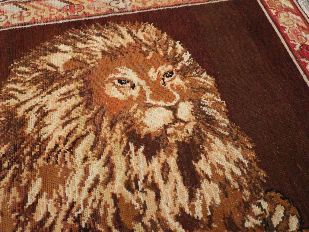 Rustic Early 20th Century Handmade East Turkestan Pictorial Lion Khotan Accent Rug For Sale
