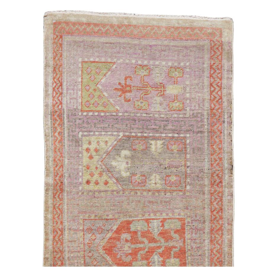 An antique East Turkestan Saph Khotan rug in runner format handmade during the early 20th century.

Measures: 2' 2