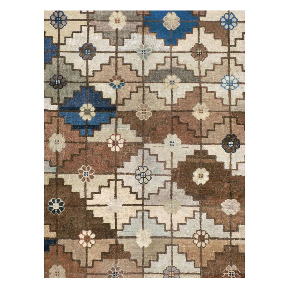 An antique Mongolian room size carpet handmade during the early 20th century with a contemporary Art Deco style geometric pattern in neutral colors.

Measures: 9' 2