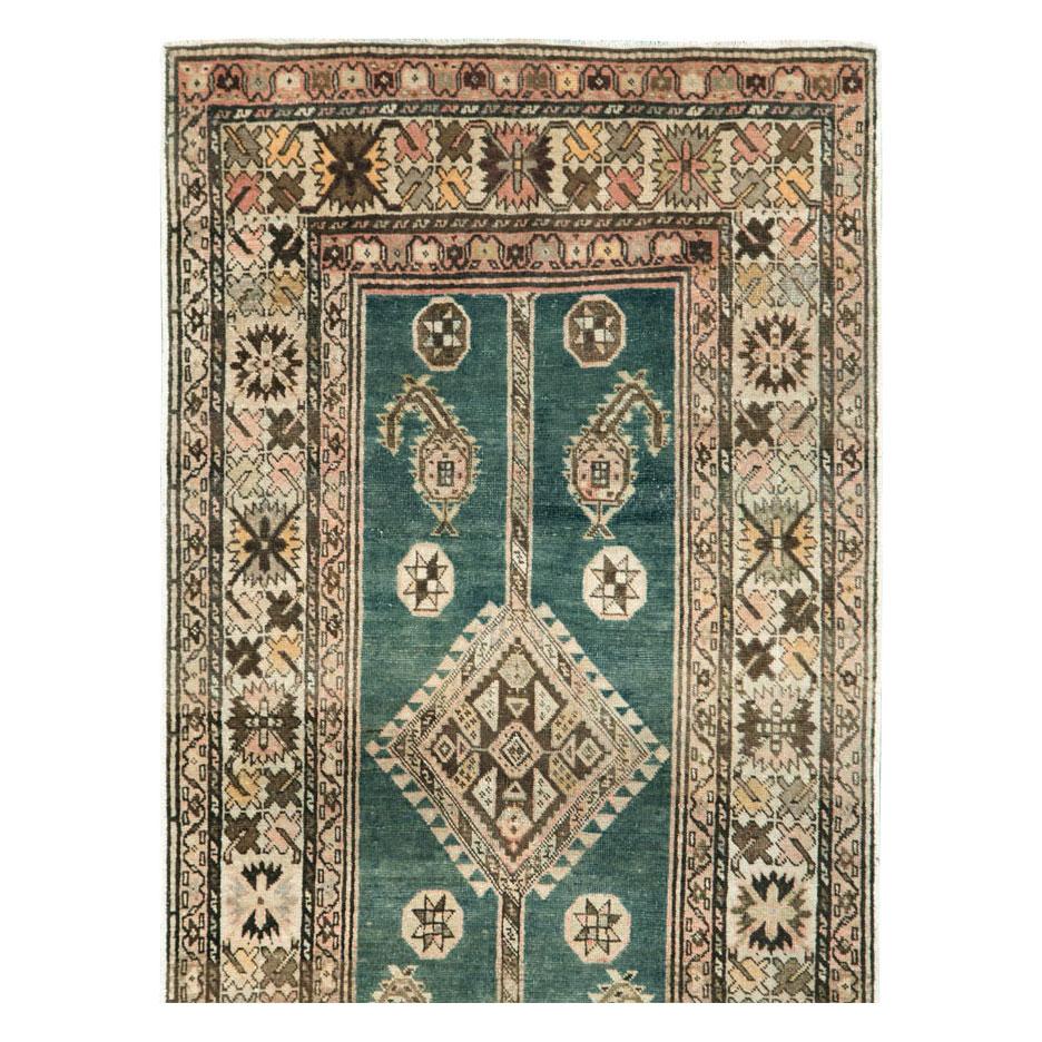 An antique northwest Persian rug in runner format handmade during the early 20th century.

Measures: 2' 11