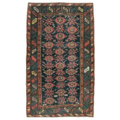 Antique Early 20th Century Handmade Persian Accent Rug in Dark Blue, Green and Light Red