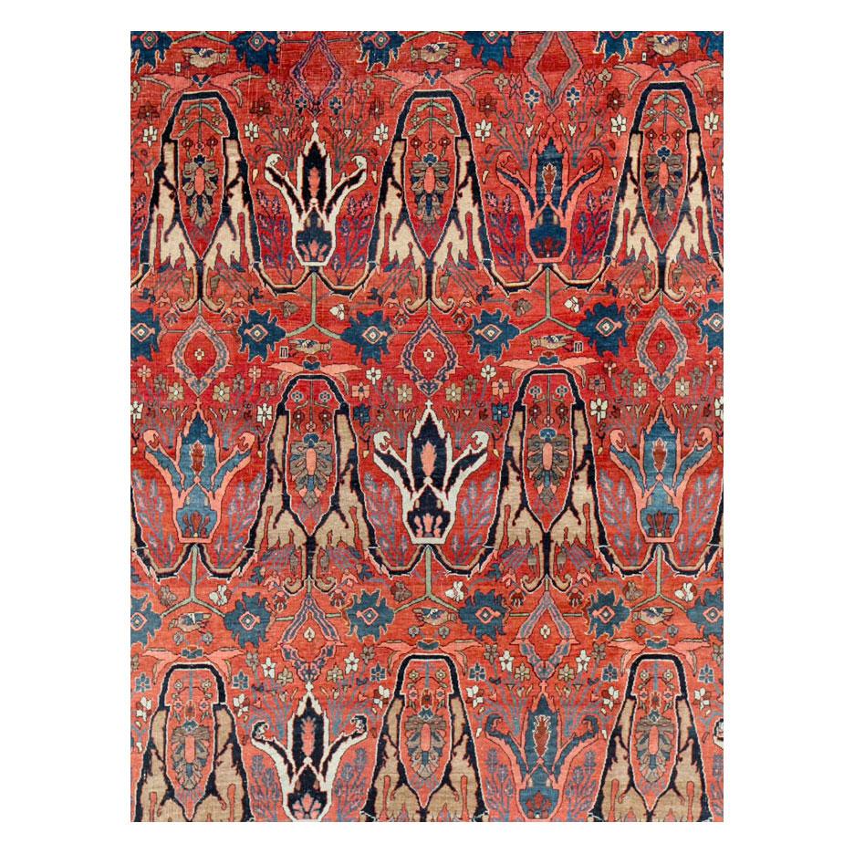 An antique Persian Bidjar room size carpet handmade during the early 20th century in shades of red and blue.

Measures: 9' 4