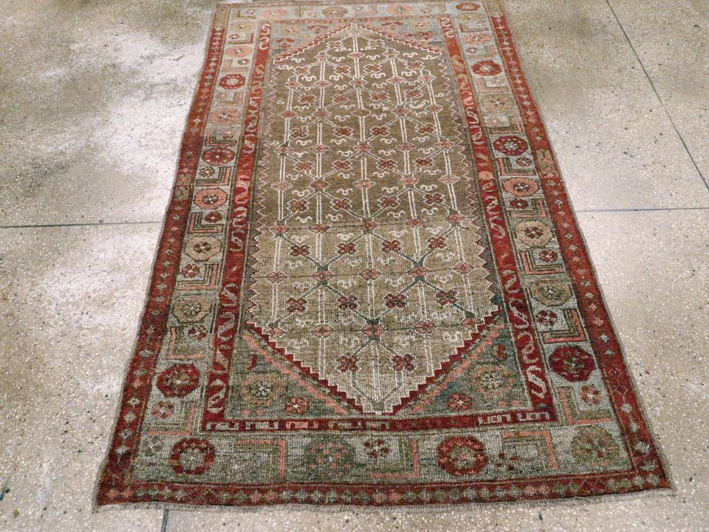 An antique Persian Camelhair throw rug handmade during the early 20th century.

Measures: 3' 10