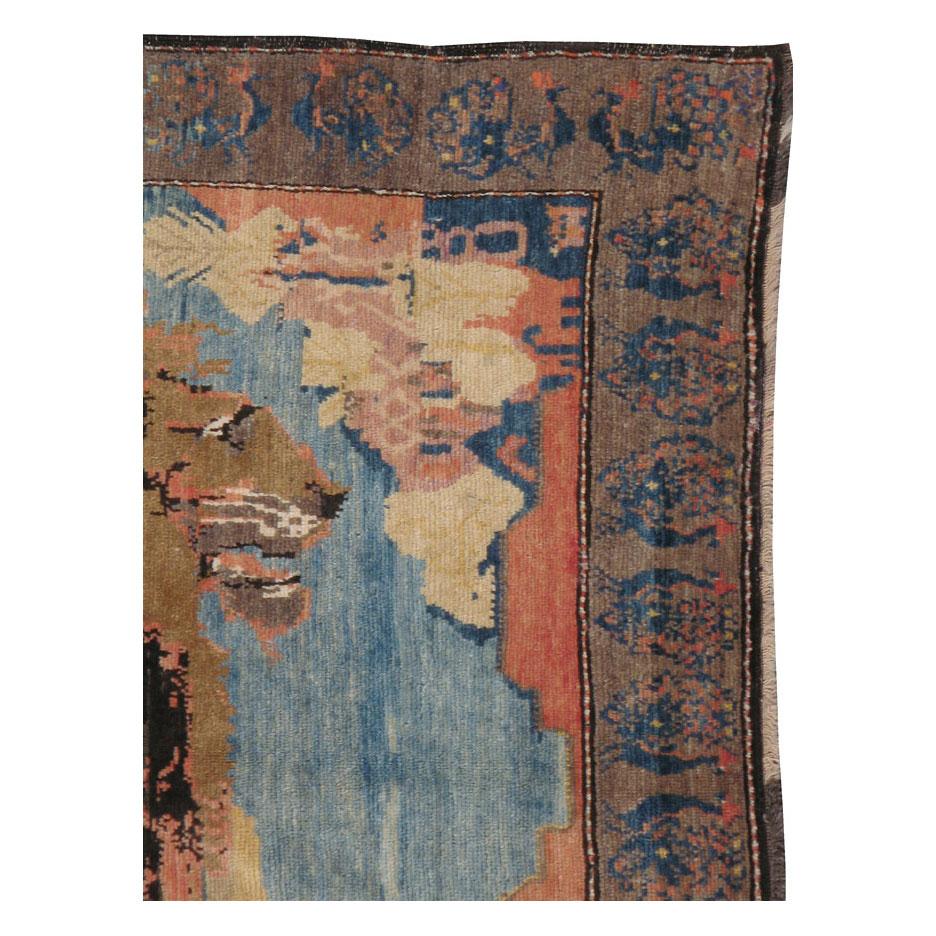 An antique Persian Gabbeh accent rug handmade during the early 20th century with a pictorial design of a lion.

Measures: 4' 11