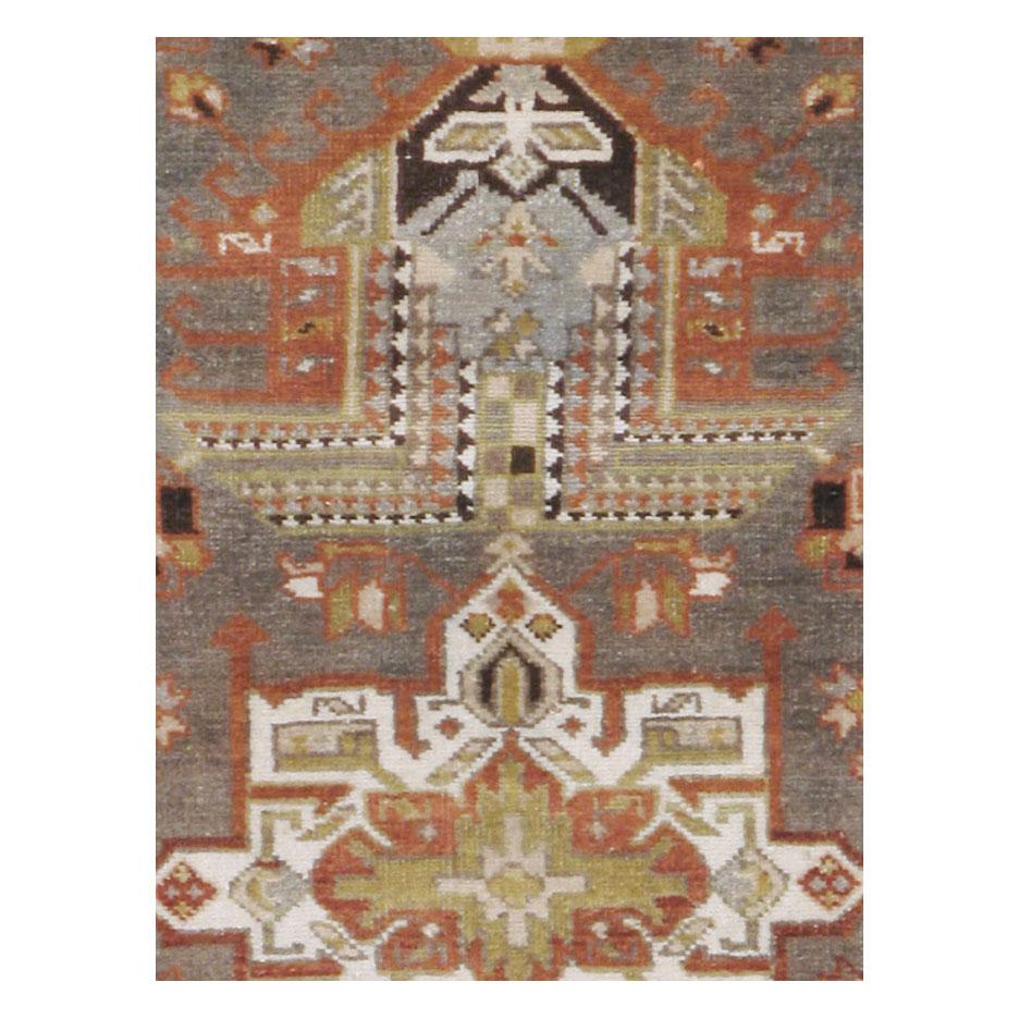 An antique Persian Heriz long rug in runner format handmade during the early 20th century.

Measures: 3' 1