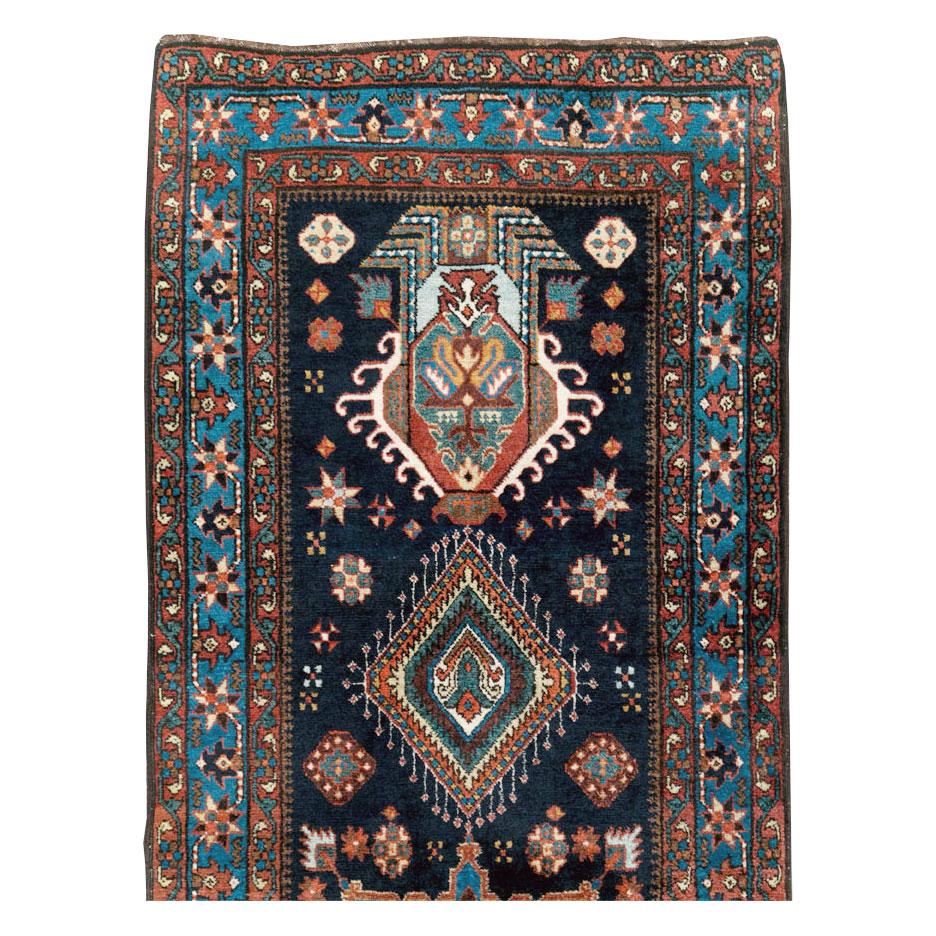 An antique Persian Heriz long rug in runner format handmade during the early 20th century.

Measures: 3' 3