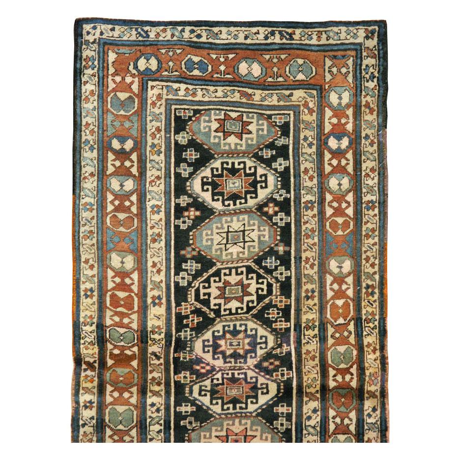 An antique Persian Kurd rug in runner format handmade during the early 20th century.

Measures: 3' 2