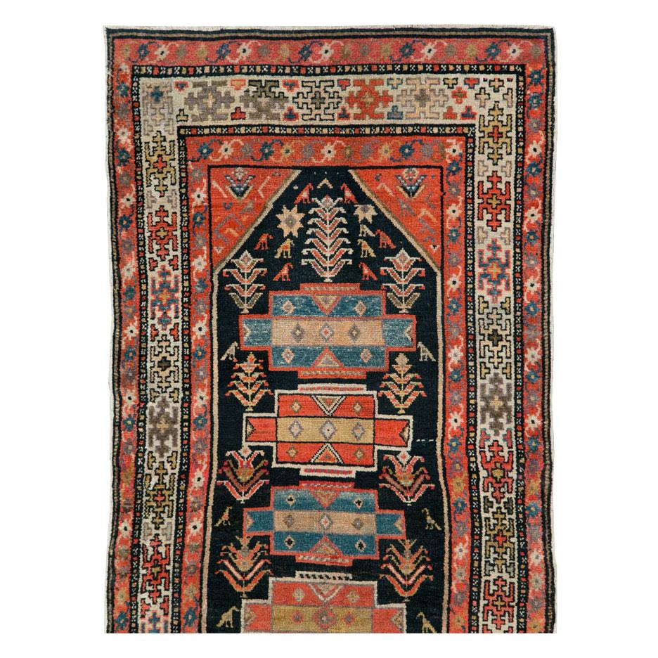 A vintage Persian Kurd rug in runner format handmade during the early 20th century.

Measures: 2' 10