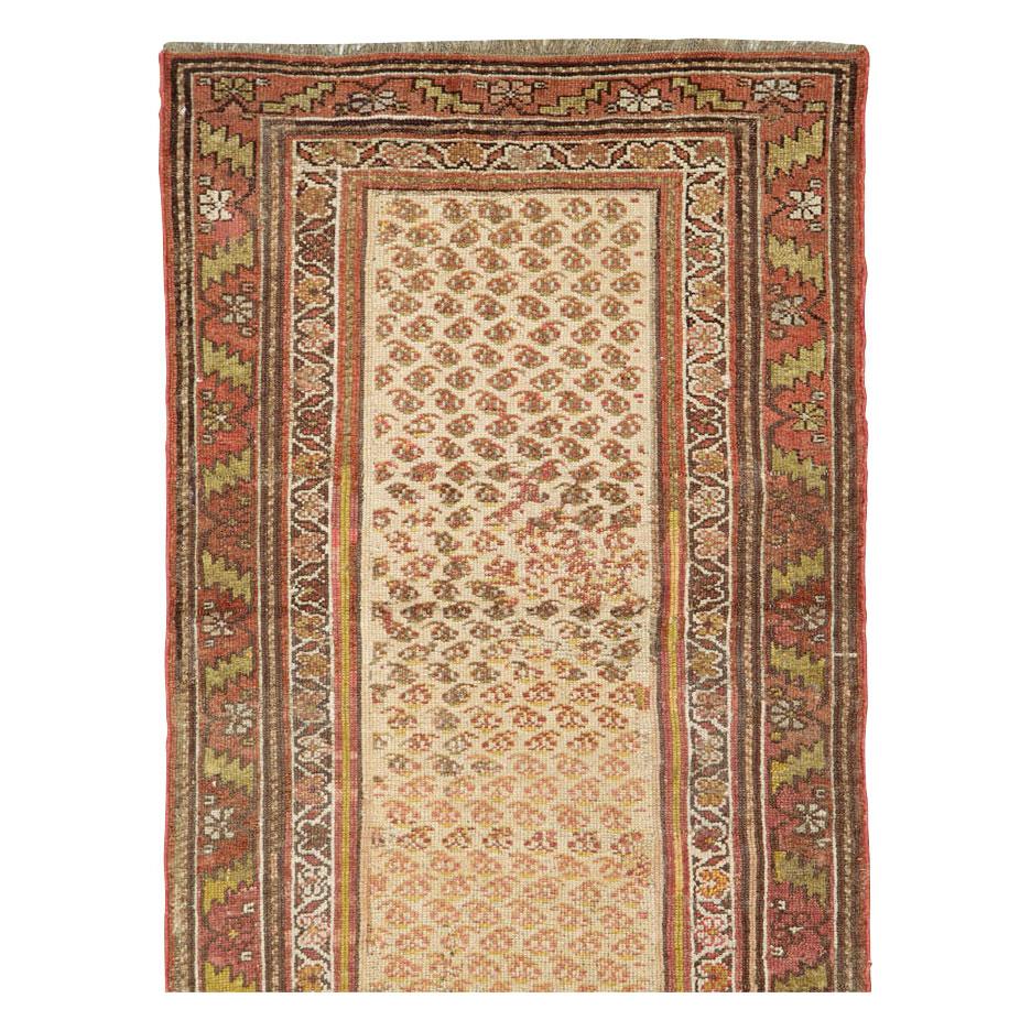 An antique Persian Kurd rug in runner format handmade during the early 20th century.

Measures: 2' 10