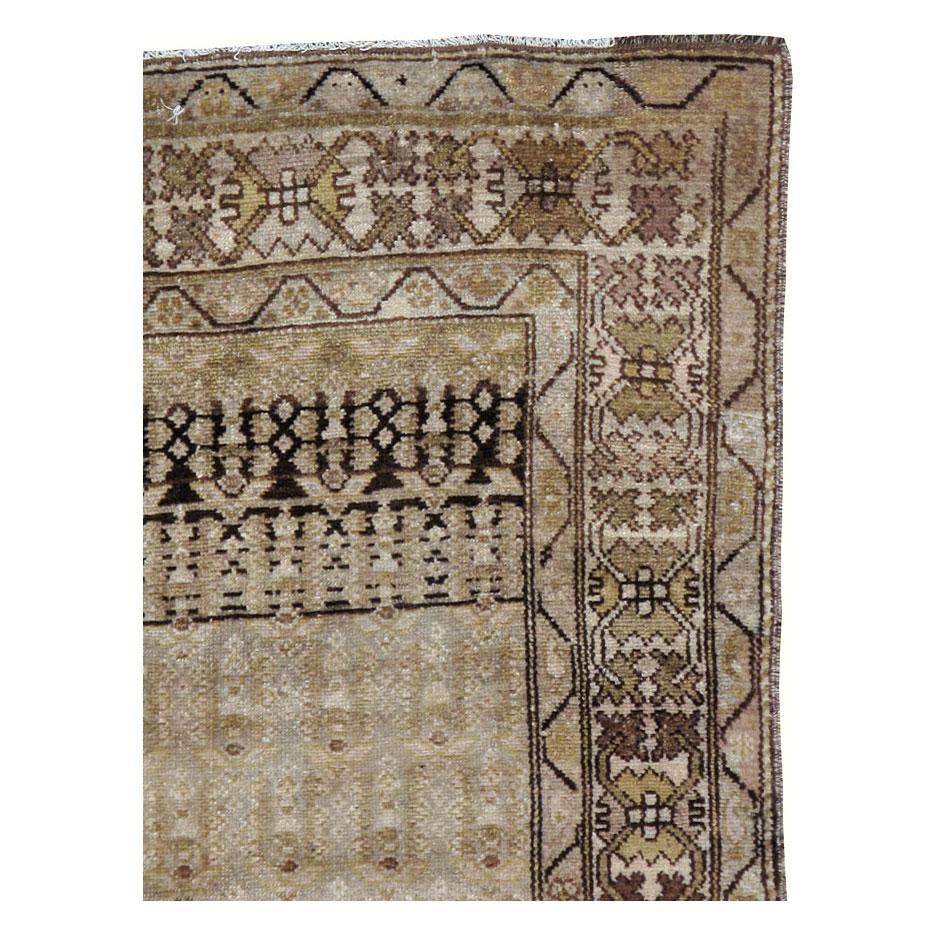 An antique Persian rug in runner format in neutral earth tones handmade during the early 20th century by the Kurdish tribes in Persia.

Measures: 3' 4