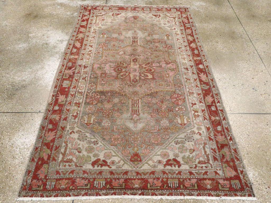 An antique Persian Kurd small accent rug handmade during the early 20th century.

Measures: 4' 2