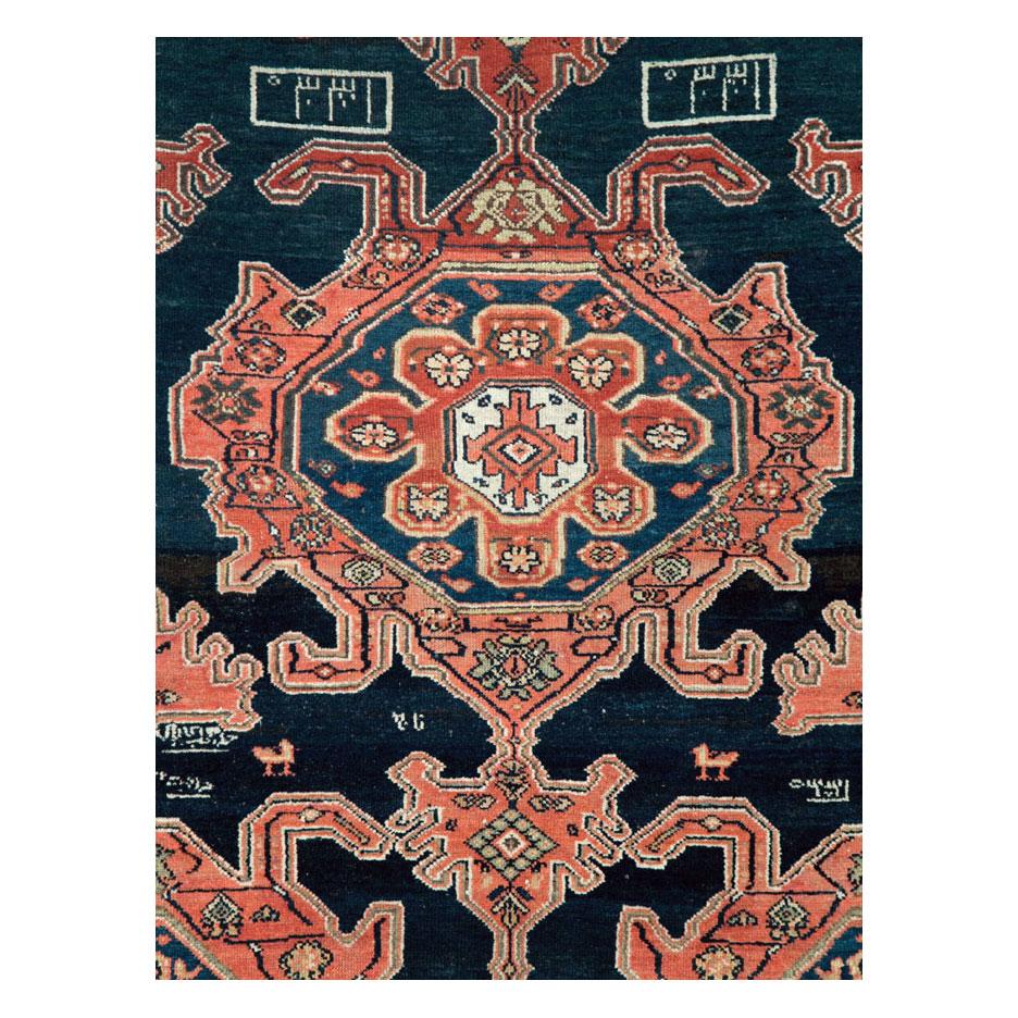 An antique Persian Malayer accent rug handmade during the early 20th century.

Measures: 4' 8