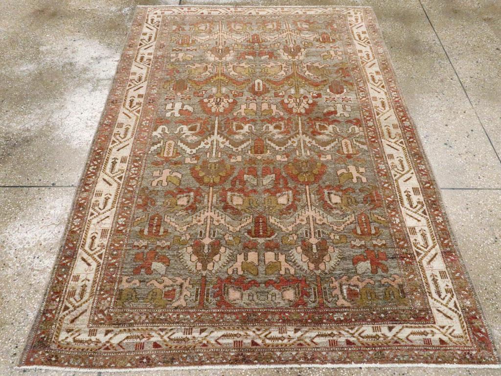 An antique Persian Malayer accent rug handmade during the early 20th century.

Measures: 4' 7