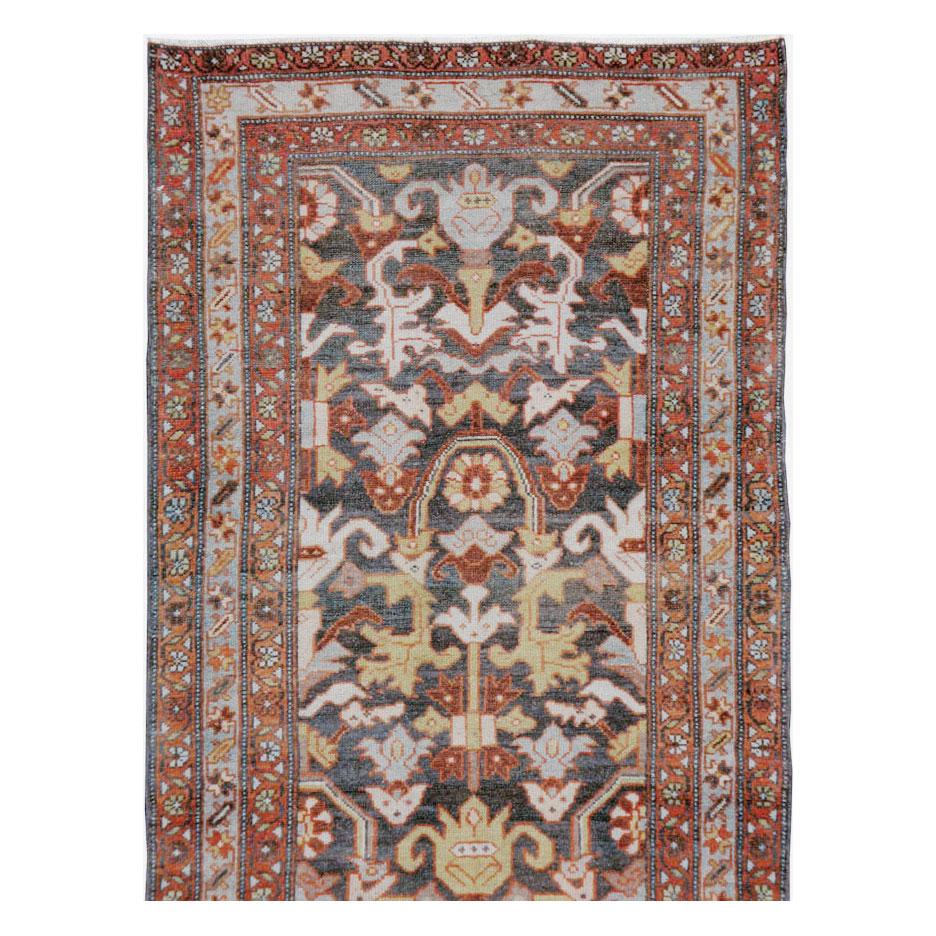 An antique Persian Malayer rug in runner format handmade during the early 20th century.

Measures: 2' 10