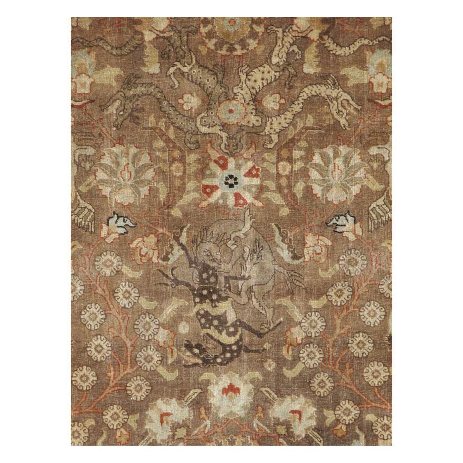 An antique Persian Tabriz pictorial accent rug handmade during the early 20th century.

Measures: 6' 1