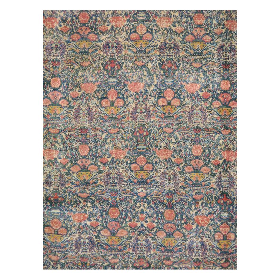 An antique Persian Tehran room size rug handmade during the early 20th century and probably inspired by mid-19th century European textiles or brocades. The pattern that is known as 'Zil-i-Sultan' which translates to 'Shadow of the Sultan' has been