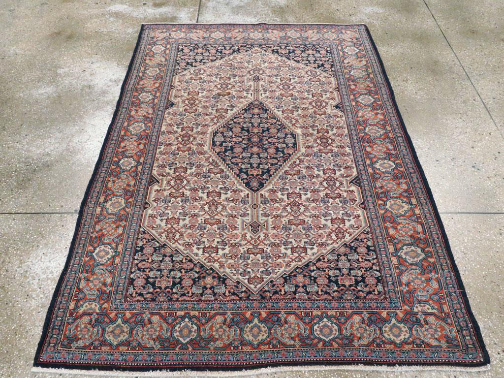An antique Persian Senneh accent rug handmade during the early 20th century.

Measures: 4' 5
