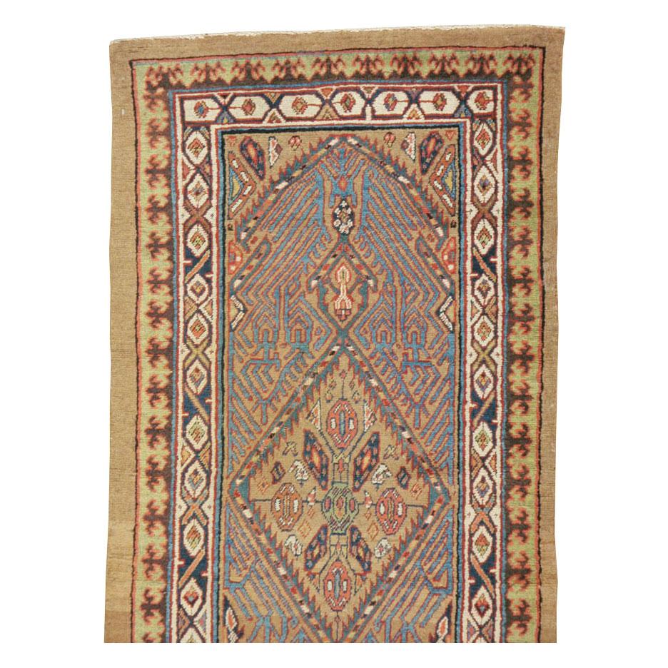 An antique Persian Serab rug in runner format handmade during the early 20th century.

Measures: 2' 11
