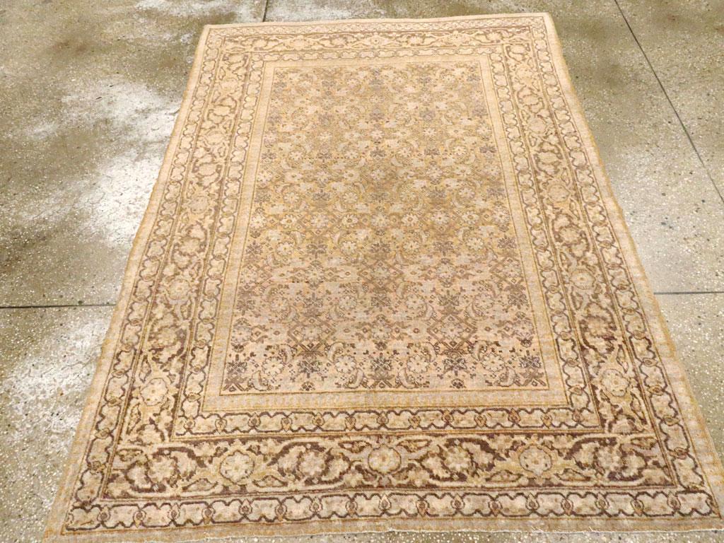 An antique Persian Tabriz accent rug handmade during the early 20th century.

Measures: 4' 6