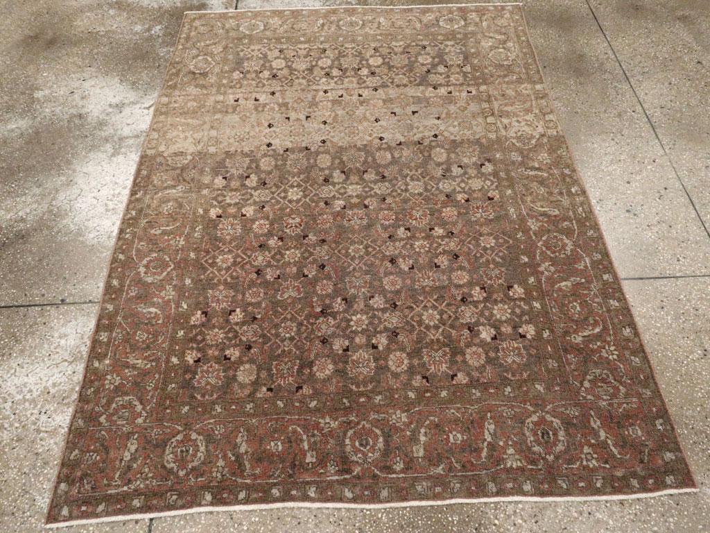 An antique Persian Tabriz accent rug handmade during the early 20th century.

Measures: 4' 7